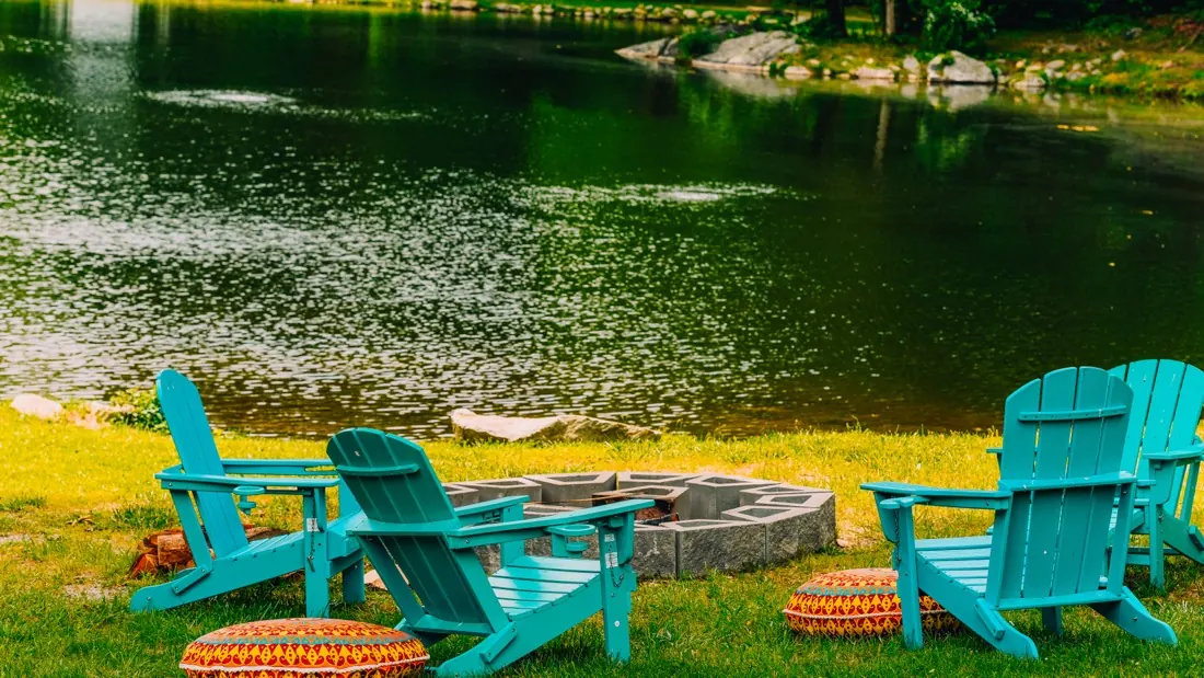 Lakeside chairs and fire ring at Woodland Trails Campground in Sussex County, NJ