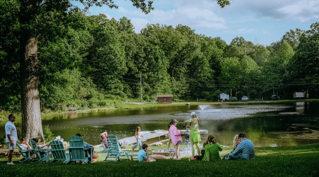 Thumbnail: Gathering by the lake at Woodland Trails Campground