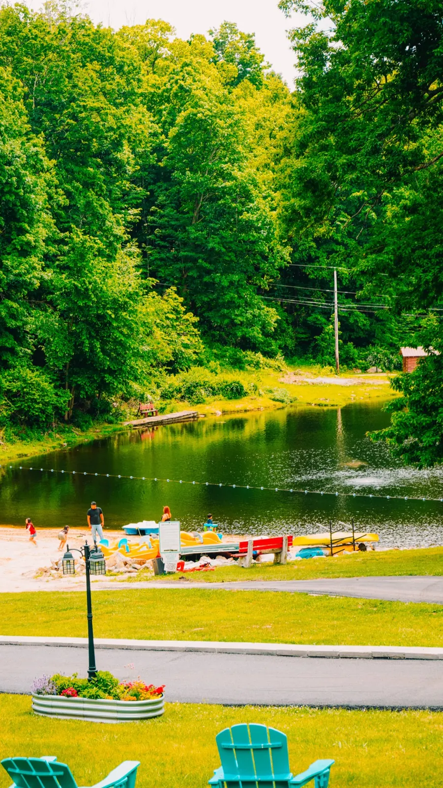 Thumbnail: Lake view through the trees at Woodland Trails Campground